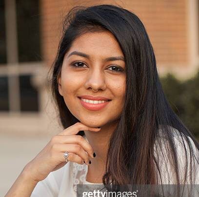 smiling female young college student of indian ethnicity